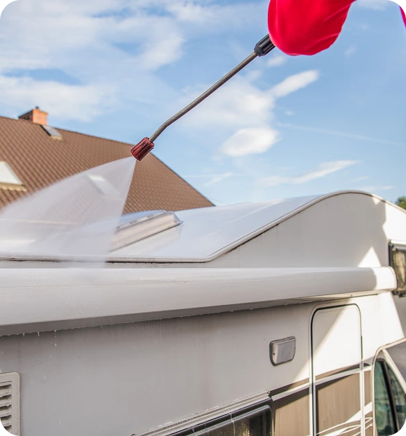 man-powerwashing-exterior-building-cleaning-walls-windows-with-highpressure-water